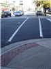 A corner of Columbia Street with new paving, ramps, and crosswalk paint