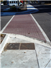 A corner of Columbia Street with new paving, ramps, and crosswalk paint